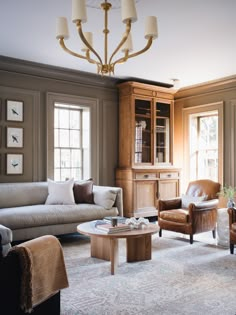 a living room filled with furniture and a chandelier