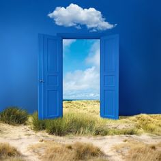 an open blue door in the middle of a desert with a sky and clouds painted on it