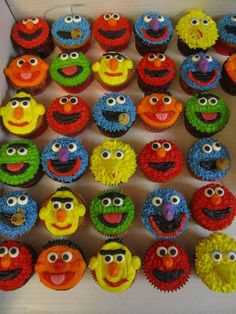 the cupcakes are decorated with different colored icing and have faces on them