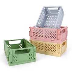 three different colored crates sitting next to each other