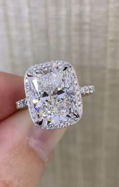 a cushion cut diamond ring with pave set shoulders