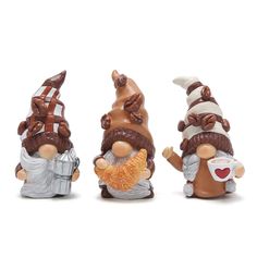 three gnome figurines sitting next to each other