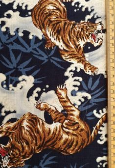 two tigers running across a blue and white background with water waves on it, one is jumping