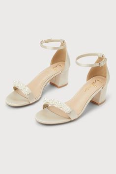 The Lulus Kutest Champagne Satin Pearl Ankle Strap Heels are a glamorous twist on a classic look! Sleek satin shapes a single sole silhouette, an almond-shaped toe bed, and a slender toe strap embellished with pearls. An adjustable ankle strap (with a silver buckle) and a sturdy heel cup top a wrapped block heel to complete the chic look!