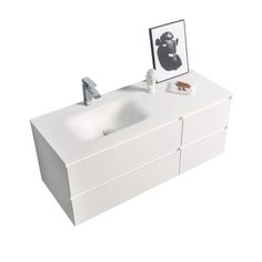 a white bathroom vanity with two sinks and a framed photo on the wall above it