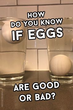 two glasses filled with eggs sitting on top of a counter