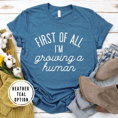 a t - shirt that says, first of all i'm growing a human