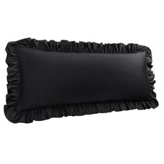 a gray pillow with ruffled edges on a white background and a black pillow case