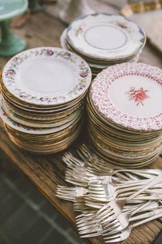 a table topped with lots of plates and silverware