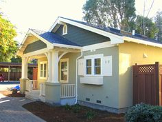 a small house with a blue roof and white trim