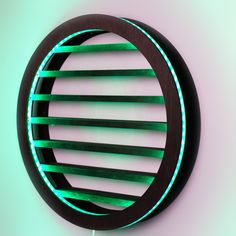 a circular wooden object with green lights on the side and black wood frame around it