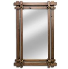 a wooden mirror hanging on the wall