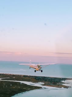 an airplane is flying low over the water