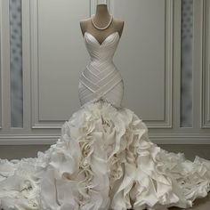 a white wedding dress with ruffled skirt