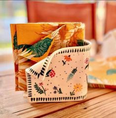 two napkins sitting on top of a wooden table