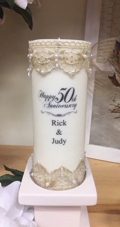 a 50th wedding anniversary candle with pearls and lace