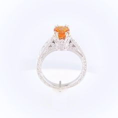 Gorgeous orange Spessartite Garnet set in a delicate modern regal setting. This ring features a hint of vintage and a lot of color. Oval 6x4mm Fancy Spessartite Garnet totals 1.48ct Setting totals 1/8ct diamonds 14k White Gold, ornate filigree detailing Size 7 - Free sizing available Please contact us to learn more or schedule a virtual appointment! Classic Citrine Ring With Center Stone, Luxury Orange Gemstone Ring, Elegant Citrine Diamond Ring With Center Stone, Orange Citrine Topaz Ring, Orange Topaz Ring With Prong Setting For Promise, Elegant Diamond Ring With Citrine Center Stone, Orange Brilliant Cut Jewelry For Gift, Luxury Orange Jewelry For Anniversary, Elegant Citrine Solitaire Ring