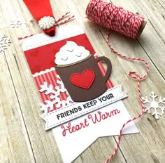 a card with a cup of coffee on it next to some twine spools