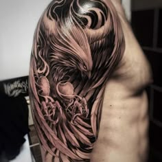 a man's half sleeve with an eagle and skulls on it