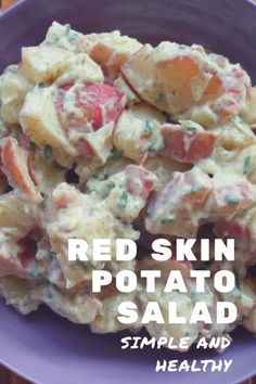 a purple bowl filled with potato salad on top of a wooden table