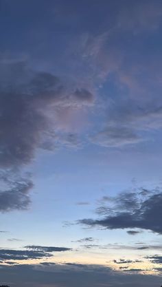 a plane is flying in the sky at dusk