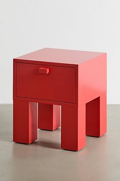 a small red table sitting on top of a floor