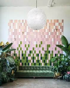 a living room filled with lots of plants and a disco ball hanging from the ceiling