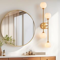 a bathroom vanity with a round mirror above it and lights on the wall next to it