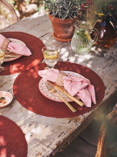 an outdoor table set with place settings for two