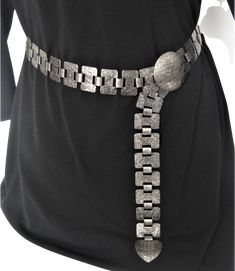 Exciting, On Trend & Rare signed Collectible Piece! Sarah Cov's women’s black and silver, metal belt. Excellent condition, size OS. Detailed measurements:Min Size Length - 9 inchesMax Size Length - 38 inchesThis SARAH COVENTRY signed belt is made of Rectangular links (1.25" x 0.75") held vertically together by 3/8" wide Book Links, Both types of links have their own embossed floral design. The Buckle face is Round (1 3/4" diameter) with a hook underneath. The hook fits into any of the holes through which the book links go. The End link is a rounded triangular shape with the same abstract embossed design as found on the buckle face. It measures 1 3/8" in both directions. If the buckle hook is placed in the book link hole of the end link, it will accommodate a 37" waist. Any of the other hol Book Links, Embossed Design, Metal Belt, Sarah Coventry, Chain Belt, The Hook, Black And Silver, A Hook, Wedding Outfit