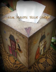 a tissue box with an image of houses on it and the words four seasons tissue cover