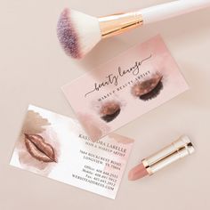 makeup and business cards laying next to each other