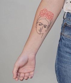 a woman with a flower in her hair tattoo on her left arm, holding out her hand