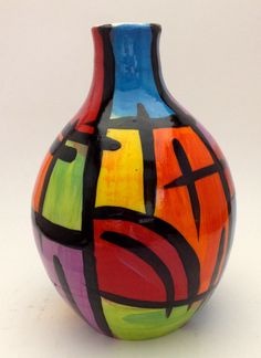 a multicolored vase sitting on top of a white table