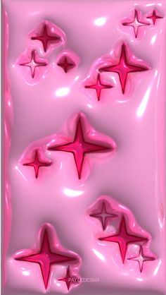 some pink stars are in the air on a pink background