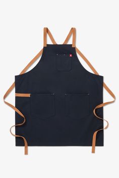 a black apron with brown straps and two pockets on the front, one pocket is open