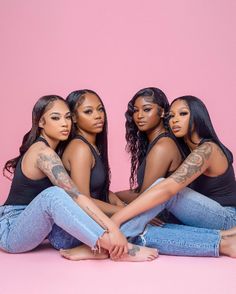 four women sitting on the floor with their arms around each other