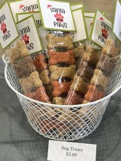 a basket filled with dog treats on top of a table next to a price sign