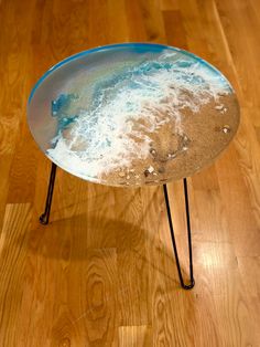 a table that is on some kind of metal stand with sand and water in it