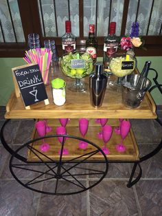 a wooden table topped with lots of drinks