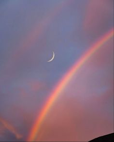 two rainbows in the sky with a half moon and a crescent on one side