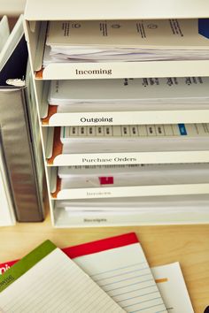 several folders stacked on top of each other in a filing cabinet with lined paper