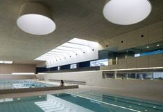 an indoor swimming pool in a large building