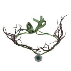 a green headpiece with branches and a broochel hanging from it's side