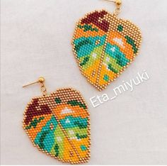 the beaded earrings are decorated with colorful leaves