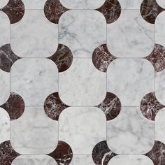 a white marble tile with brown and black circles in the middle, on top of it