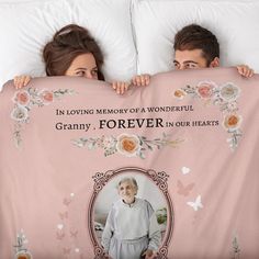 two people hiding behind a blanket that says in loving memory of a wonderful granny, forever in our hearts