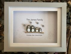 three penguins sitting on a shelf with the words, the james family framed in it