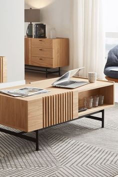 a living room scene with focus on the coffee table and entertainment center in the background