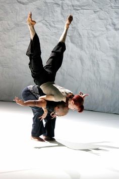 two people are doing tricks on the floor